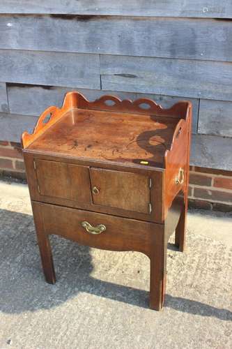 A 19th century mahogany tray top washstand enclosed two door...