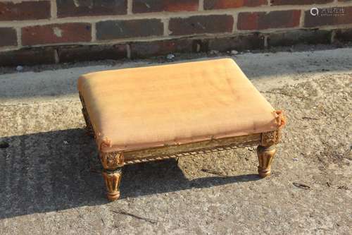 A 19th century carved giltwood stool, on turned faceted supp...