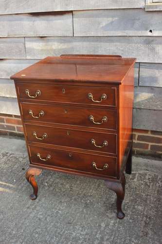 An early 19th century mahogany ledge back chest of four long...