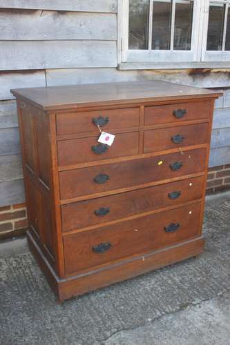 A late 19th century oak chest of four short and three long g...