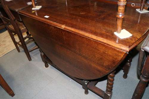 An oak oval top drop leaf dining table, on barley twist stre...