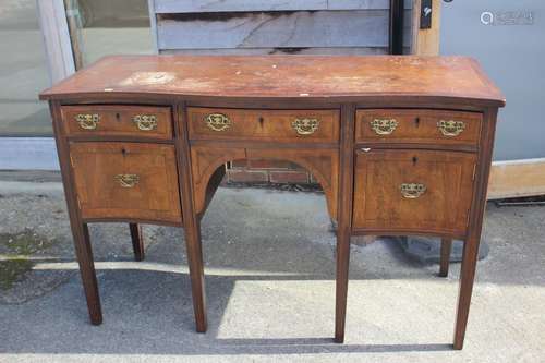 A mahogany and banded serpentine front sideboard, fitted thr...