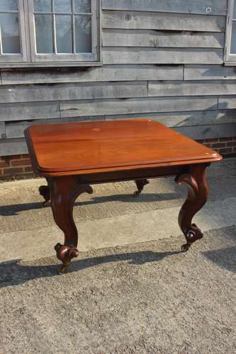 A Victorian carved mahogany extending dining table with two ...