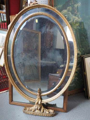 A 19th century oval carved giltwood framed wall mirror with ...