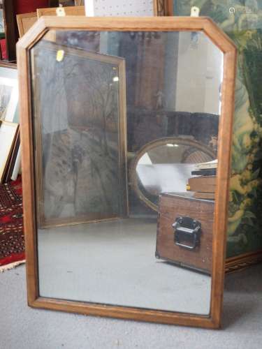 A 1930s oak rectangular framed wall mirror with cut corners,...