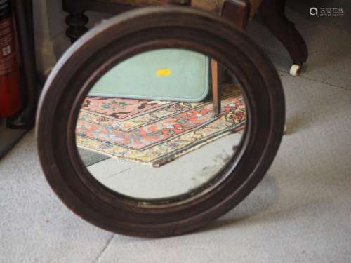 An oak framed circular wall mirror, 18 1/2 dia overall