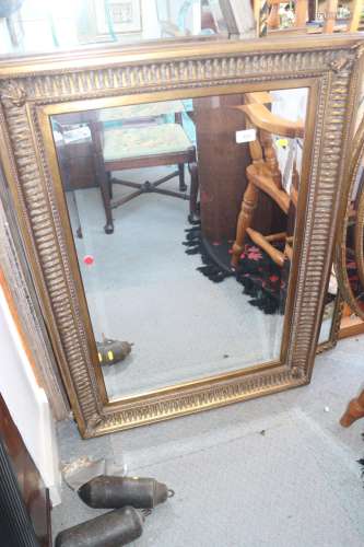 A wall mirror in deep fluted frame with bevelled plate, 30 x...
