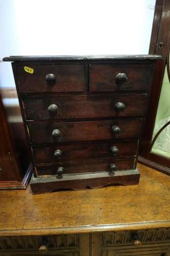 A polished as mahogany miniature chest of two short and four...