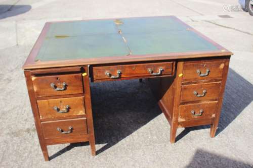 A partners early 20th century walnut double pedestal desk wi...