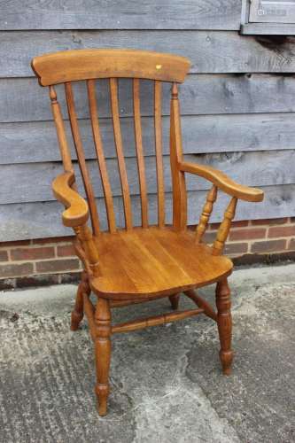 A modern oak Windsor lath back elbow chair