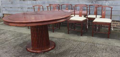 A Chinese hardwood circular dining table, fitted four frieze...