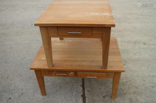 A light oak coffee table, fitted four drawers, on square tap...