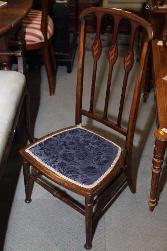 An Edwardian low seat vertical rail back chair and a Sutherl...