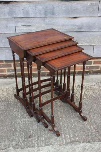 A nest of four mahogany quartetto tables of Regency design, ...