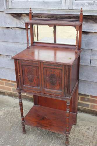 A side cabinet with raised mirror back over two doors and un...