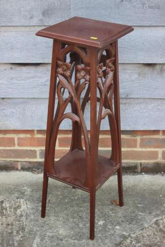 An early 20th century carved mahogany jardiniere stand with ...