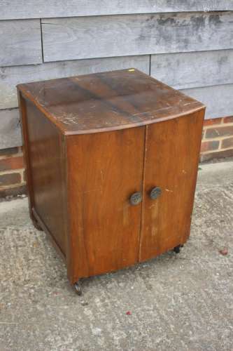 A walnut bowfront bedside cupboard, 20 wide