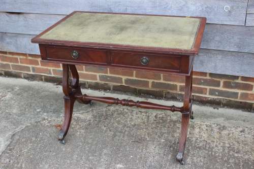 A mahogany writing desk of Georgian design with green tooled...