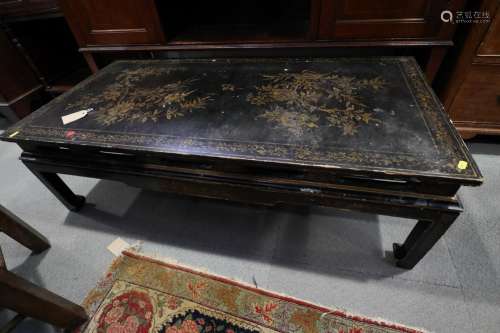 A Chinese black and gold lacquered low occasional table, on ...