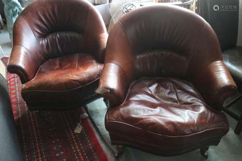 A pair of Art Deco design dark tan leather tub-shape armchai...