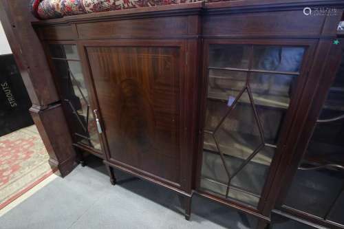 A 1930s breakfront display cabinet with centre panel door an...