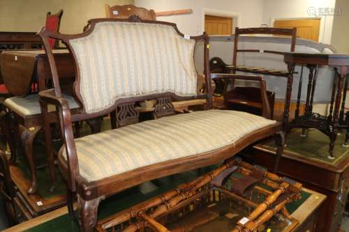 An Edwardian walnut two-seat settee with padded seat and bac...
