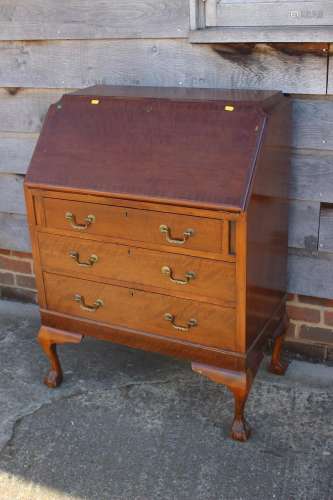 A mahogany fall front bureau with fitted interior over three...