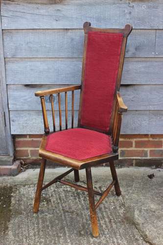 A polished as walnut spindle back elbow chair, upholstered i...