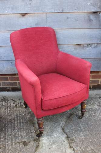 An oak framed armchair, upholstered in a red fabric, on turn...