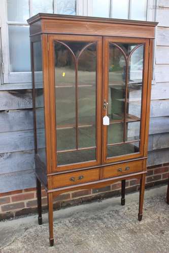 An Edwardian walnut banded and line inlaid display cabinet w...