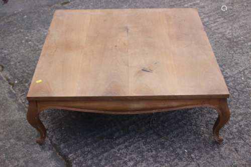 A faded mahogany low occasional table/coffee table, on cabri...