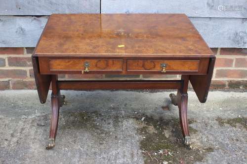 A figured walnut flap top coffee table, fitted two drawers, ...