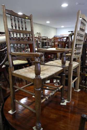 A set of six oak spindle back dining chairs with rush envelo...