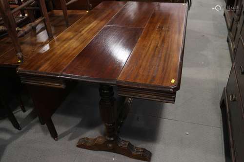 An early 20th century mahogany extending dining table with e...