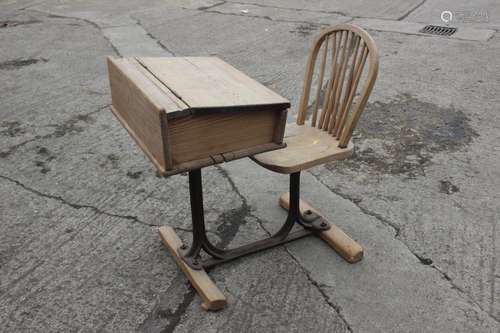 A McCarthy Brothers cast iron and pine school desk with atta...