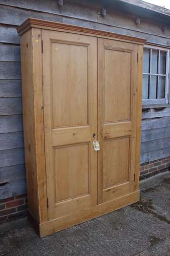 A pine cupboard, fitted five shelves enclosed two doors, on ...