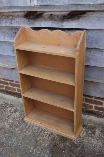 A pine bookcase, fitted four shelves, 26 wide x 7 1/2 deep x...