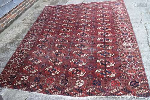 An antique Bokhara carpet of traditional design with forty-e...