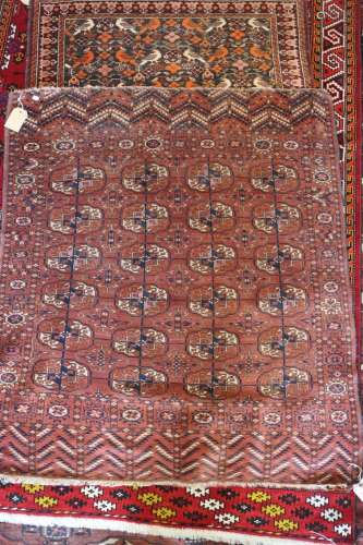 An antique Bokhara rug with twenty-four guls in traditional ...