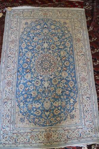 A Kashan wool and part silk pile rug with star medallion and...