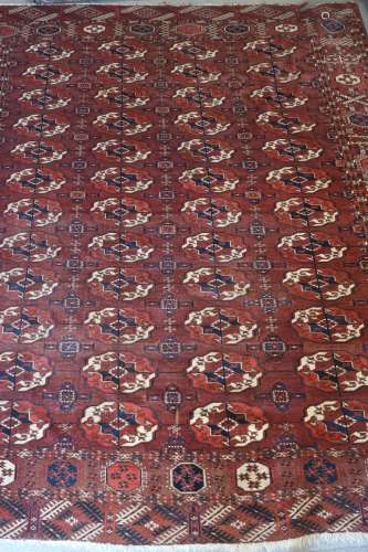 A Bokhara rug of traditional design with eighty-four guls on...