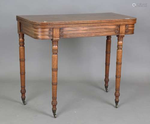A George IV mahogany fold-over tea table, the hinged top abo...