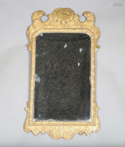 A fine George I giltwood pier mirror, the shaped frame finel...