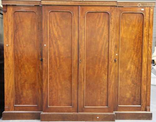 A mid-Victorian mahogany breakfront four-door wardrobe, the ...