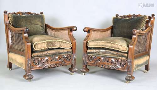 A pair of early 20th century walnut framed bergère armchairs...