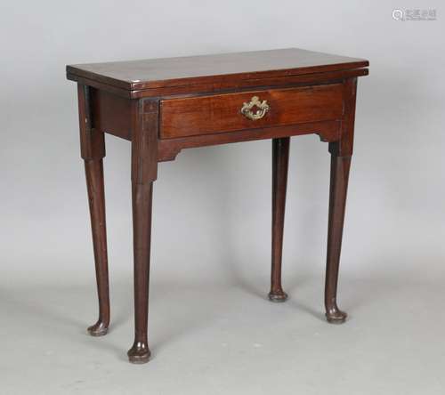 A George II mahogany fold-over tea table, the hinged top abo...