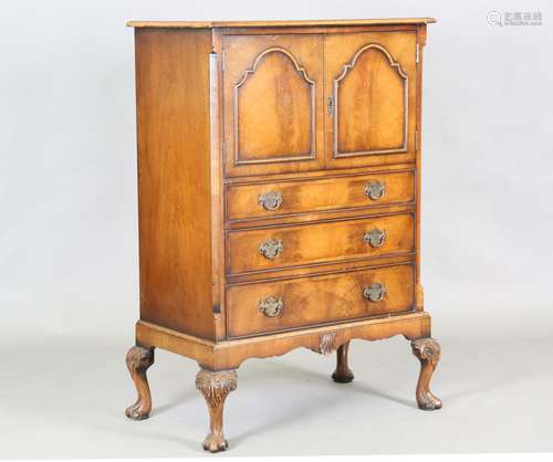 An early 20th century Queen Anne style walnut cabinet-on-che...