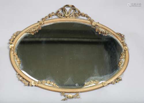 An Edwardian gilt composition oval wall mirror, the reeded f...