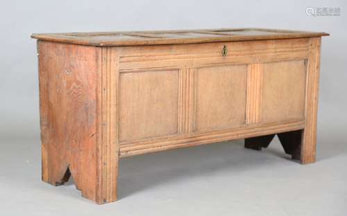 An early 18th century oak panelled coffer, the hinged lid wi...