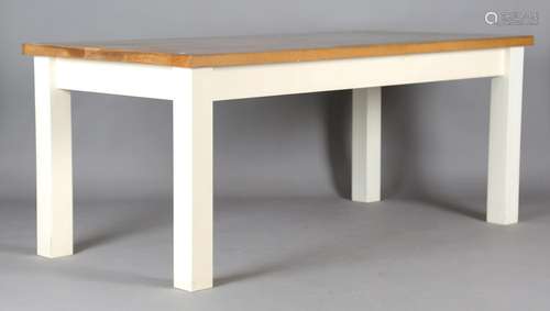 A modern oak rectangular dining table, raised on painted blo...